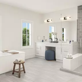 Lavish bath boasts dual sink vanities, free-standing tub, and luxe shower