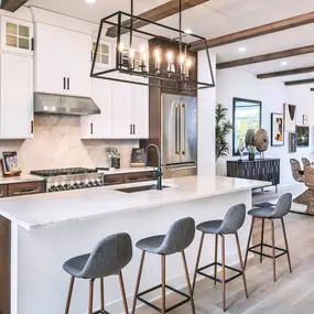 Gorgeous kitchens with large center islands, brand-named stainless steel appliances, and granite countertops