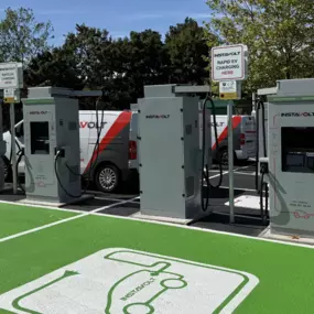 A row of InstaVolt ultra-rapid chargers in a spacious car park with clearly marked EV-only bays and easy access for electric vehicles.
