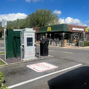 An InstaVolt ultra-rapid charger is installed beside McDonald's at Marus Bridge Retail Park in Wigan. The location offers convenient access to food and drink while charging.