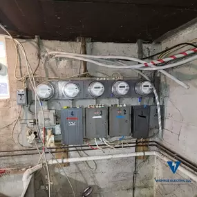 Indoor basement multi-unit meter panel system serviced by Wehrle Electric LLC, licensed electricians in Covington KY serving a 40-mile radius.