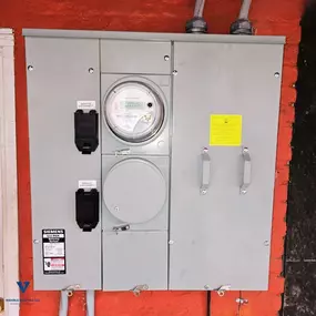 Outdoor Siemens electrical meter panel mounted on wall installed by Wehrle Electric LLC, local electricians in Covington KY serving a 40-mile service area.