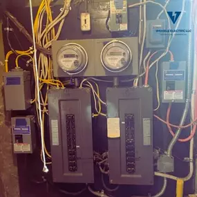 Dual breaker panels with utility meters and wiring maintained by Wehrle Electric LLC, licensed electricians in Covington KY serving a 40-mile area.