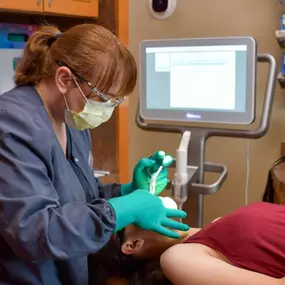 A dentist at Dental Depot's dental clinic in Yukon examines a patient.
