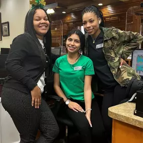 The Dental Depot dental team poses for a photo at the front desk of the dental clinic in Tulsa