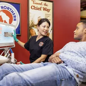 A dentist discusses a dental treatment plan with a patient.