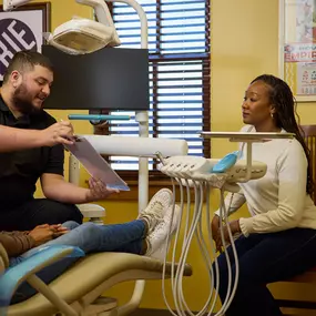 A dentist discusses treatment with a patient at Dental Depot's Mustang dentist office