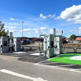 InstaVolt ultra-rapid chargers installed at Halls Retail Park, Bury, with clear line of sight to TK Maxx and Argos stores across the car park.