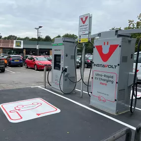 Two InstaVolt ultra-rapid EV chargers located in a busy retail car park on Tollbar Way, Southampton, with McDonald's visible in the background.