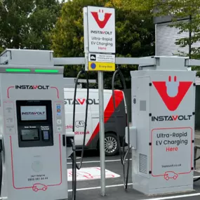 Front-facing view of InstaVolt ultra-rapid EV charging bays in Southampton, featuring clear signage and branding within a well-marked retail car park.