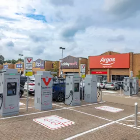 Multiple InstaVolt ultra-rapid EV chargers located in a busy retail park with nearby stores including Argos, Hobbycraft, and ALDI.