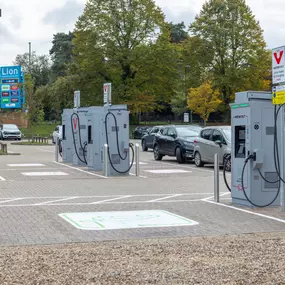 Ultra-rapid InstaVolt chargers positioned at Lion Shopping Park, offering convenient EV charging beside retail and green surroundings.