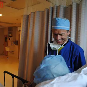 Dr. Konrad Filutowski speaks with a patient after surgery