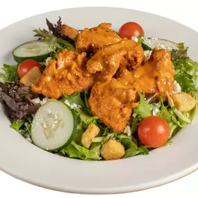 Fresh salad with Anchor Bar Original (Medium) tenders on top.
