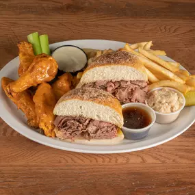 Slow roasted roast beef on a fresh kimmelweck roll alongside 5 Original (Medium) chicken wings.