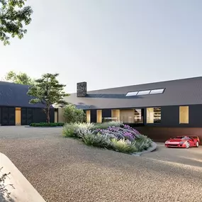 Modern black timber farmhouse with pitched roofs and landscaped driveway in Dorset.