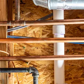 Water heater (tankless) being installed–components and control unit visible in mechanical room.