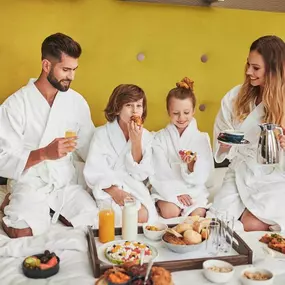 Family in the room eating breakfast