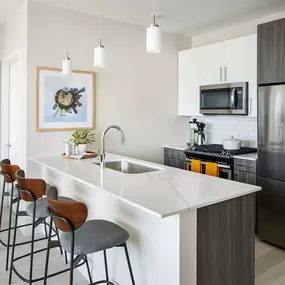 Spacious Kitchen with Island and Stools at Sentral Michigan Ave