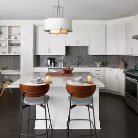 Large Kitchen and Island Counter with Stools at Sentral East Austin at 1614 E. 6th