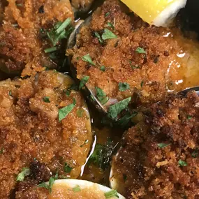 Little Neck  Clams topped with seasoned bread crumbs in a garlic sauce