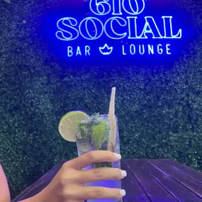 Mojito with 610 SOCIAL light up sign behind it