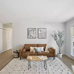 Open concept living room with hardwood floors and natural lighting.