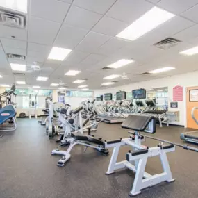 Fitness center with cardio machines and free weights.