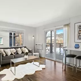 Open concept living room with hardwood floors and ample natural light.