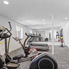 Fitness center with free weights and cardio machines.
