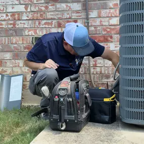 Sailor's technician repairing an air conditioner.