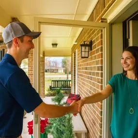 Sailor's Technician shaking hands with a happy customer.