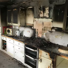 This image clearly shows the result of significant fire damage in a residential kitchen. This is a very useful visual for demonstrating the need for professional restoration services like yours.