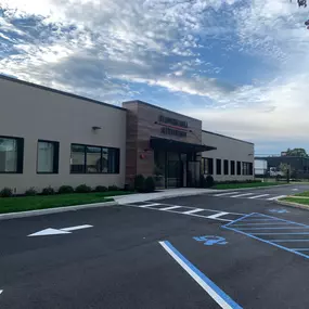 Exterior view of Flower Hill Auto Body of Huntington, featuring the newly constructed, state-of-the-art facility with modern architecture, accessible parking, and clean landscaping. Located at 15 West Stepar Place in Huntington Station, this advanced collision repair center represents Flower Hill’s commitment to quality craftsmanship, customer care, and OEM-certified repairs.