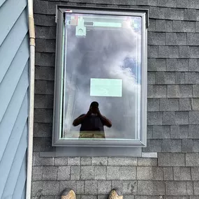New skylight installation on a residential roof with fresh flashing and shingle integration, completed by Selective Homes Roofing & Siding on Long Island.