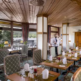 Im Restaurant 'Vier Täler' des Maritim Hotels Titisee genießen Gäste ein köstliches Dinner mit atemberaubendem Seeblick. Das elegante Ambiente und die feine Küche bieten ein unvergessliches Abendessen.