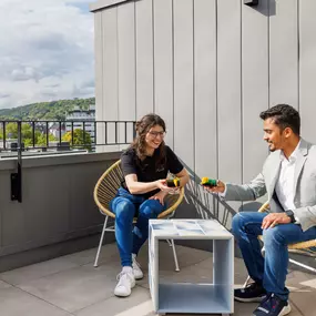 Terrace in the community space with view of the Aachen Cathedral