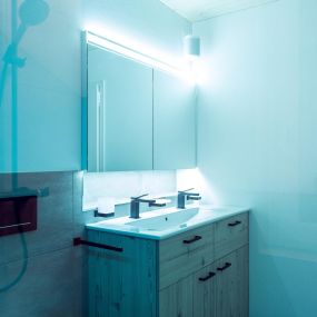 Badezimmermöbel und blaues Duschglas