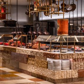 The meat station at the Bacchanal Buffet in Las Vegas Caesars Palace is a feast for the eyes as much as for your stomach. The Bacchanal Buffet is the largest buffest in Las Vegas with over 10 kitchens, 9 chef-attended stations, 250+ menu items, and infinite flavors.