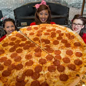 These slices are huge. In fact, they're calling it the largest slice on the Strip. The chefs import fresh ingredients from Naples, Italy, like our pomodorini pelati tomatoes, which makes the pizza sauce much sweeter and more intensely flavored.