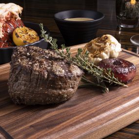 Steak and sauces on cutting board at Jack Binion’s Steak, inside Horseshoe Las Vegas. Jack Binion delivers on the legacy of the Binion name with an acclaimed selection of steaks cooked to perfection in an 1800-degree double broiler. Indulge in our seafood tower, innovative side dishes or satisfy your sweet tooth with a delectable dessert. Sip signature cocktails or choose your favorite drink from our award-winning wine and beer selection, right in the heart of the famed Vegas Strip.