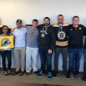 Omni Logistics employees dress up in Boston gear in the Billerica office