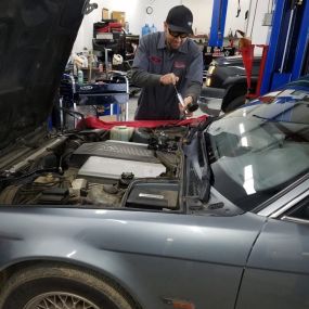 Hugo performing coolant pressure check on a classic BMW, safety first!
