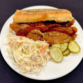 Pork sandwich with cole slaw and pickles