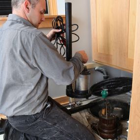 Plumber Installing Sump Pump