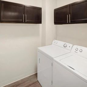 Laundry room at Burwick Farms Apartment Homes at Howell, MI