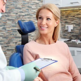 A dentists speaking with his patient