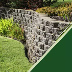 retaining wall with plants frames grassy yard