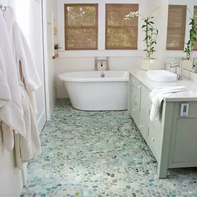 Pebble tile mosaics add a natural touch to spaces in your home including backsplashes, floors, and walls. Each organically shaped stone is selected to fit perfectly together to create an indoor oasis. Pebble stone tiles are available as raised or flat pebbles, polished or rough surface textures and in a variety of colors.