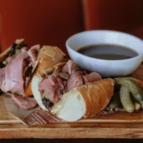prime rib sandwhich, shaved prime rib, cola-caramelized onions, swiss cheese, horseradish aioli, butter toasted hoagie, au jus